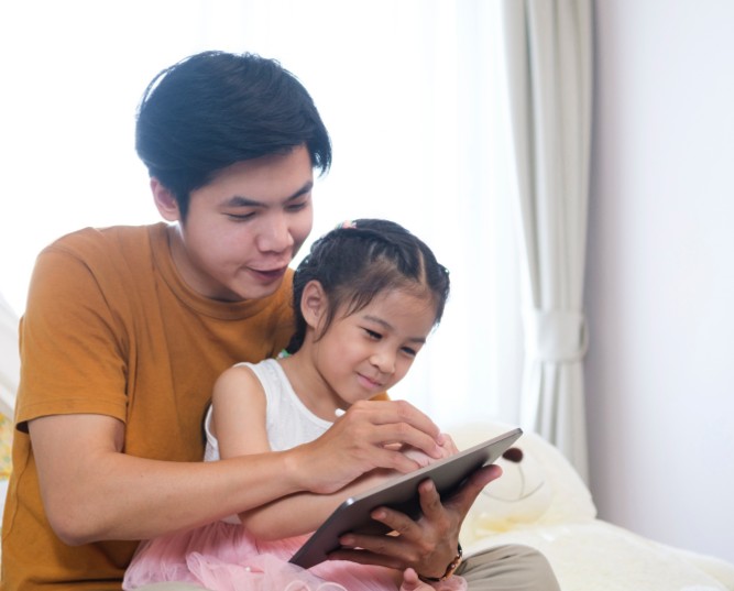 Asian father is helping and support parents teaching homework.