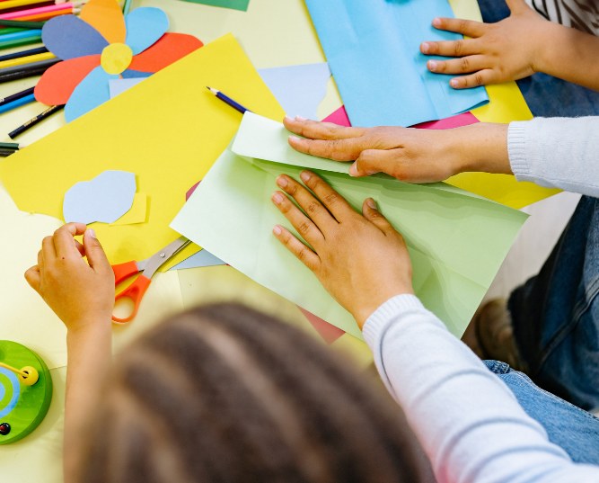 Woman and Children Doing Art With Colored Papers