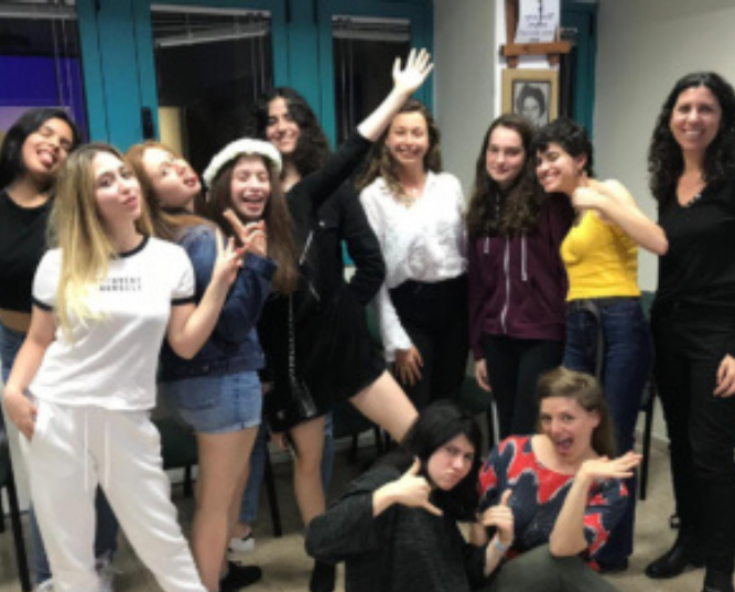 Woman Working on a Laptop Wearing a Headset